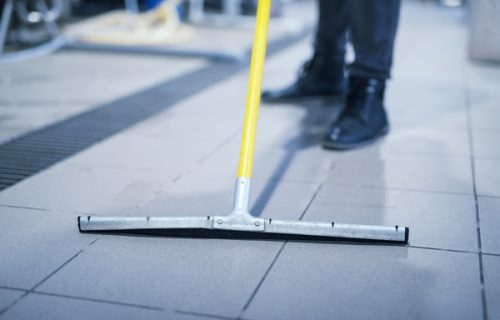 Close up of floor wiper mop cleaning industrial plant. Close up of floor wiper mop cleaning industrial plant.